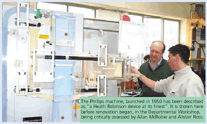 The Phillips machine, launched in 1950 has been described as 'a Heath Robinson device at its finest'. It is shown here before renovation began, in the Departmental Workshop, being critically assessed by Allan McRobie and Alistair Ross.